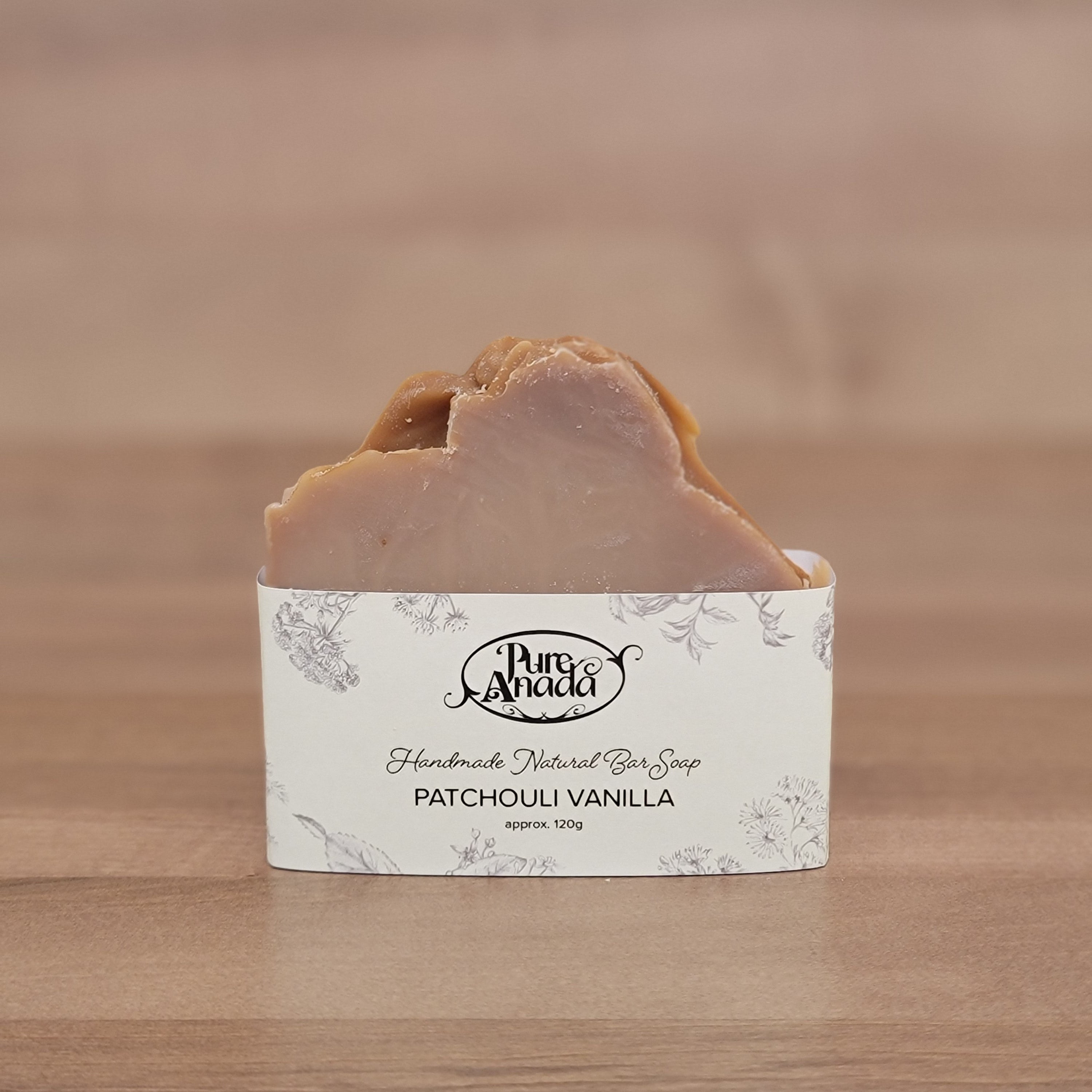 Bar of handmade soap with a label on a wooden surface